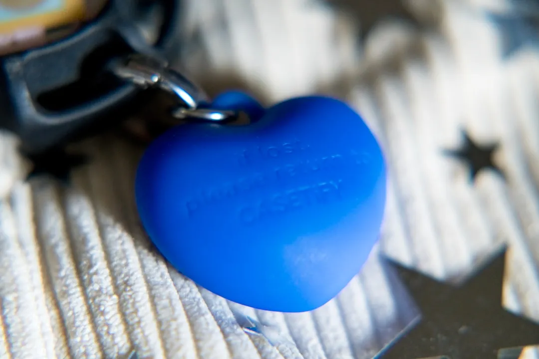 A blue heart-shaped charm on a keychain.