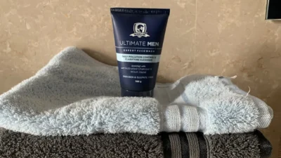 white and blue tube bottle on gray textile