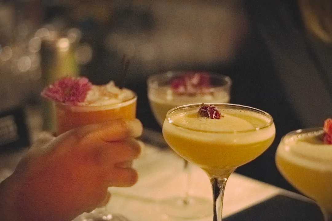 Delicious cocktails adorned with pink flowers.
