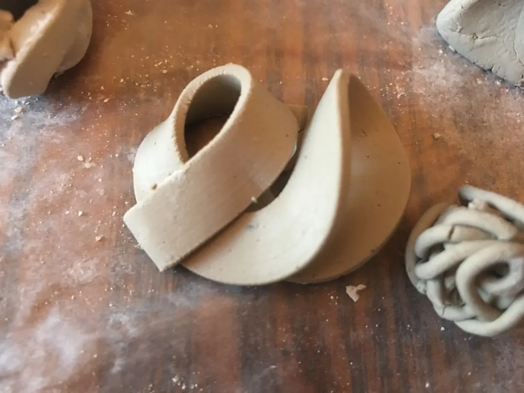 white ceramic figurine on brown wooden table