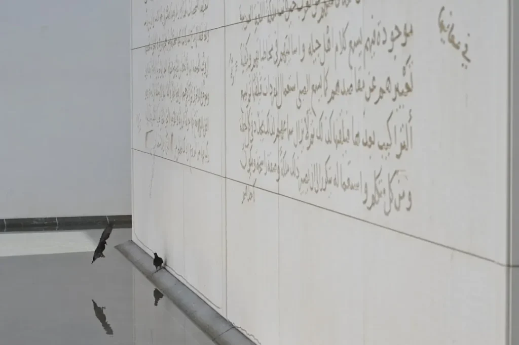 Arabic script inscribed on a white wall