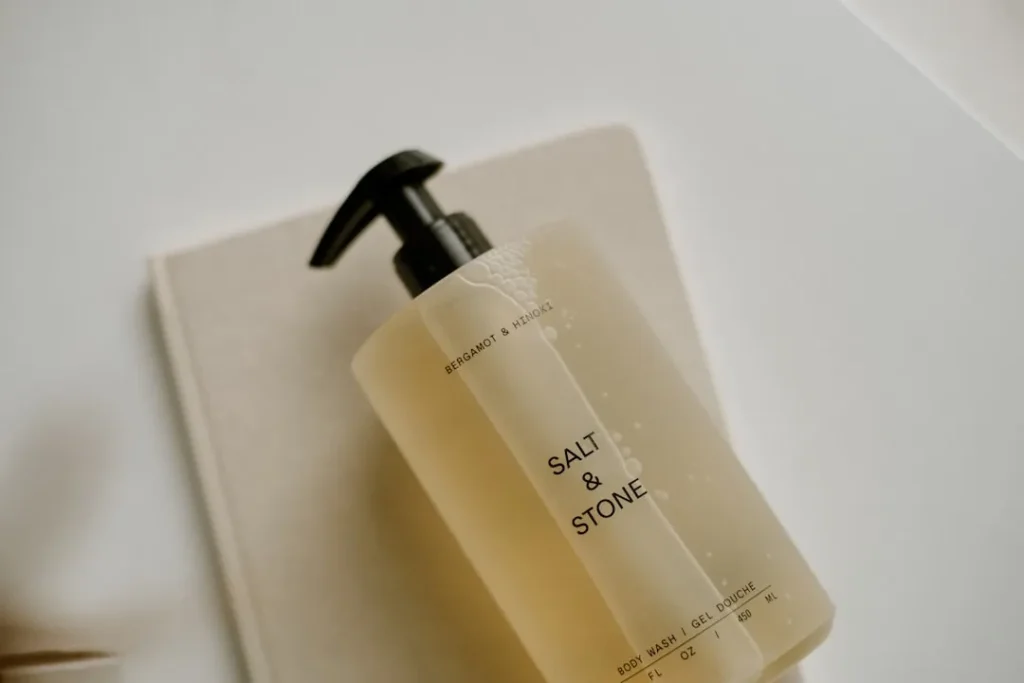 a bottle of soap sitting on top of a soap dispenser