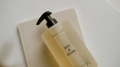 a bottle of soap sitting on top of a soap dispenser