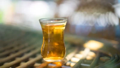 clear drinking glass with brown liquid
