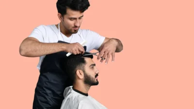 a man cutting another man's hair
