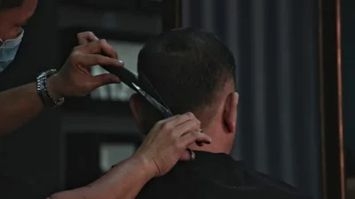 barber cutting man's hair