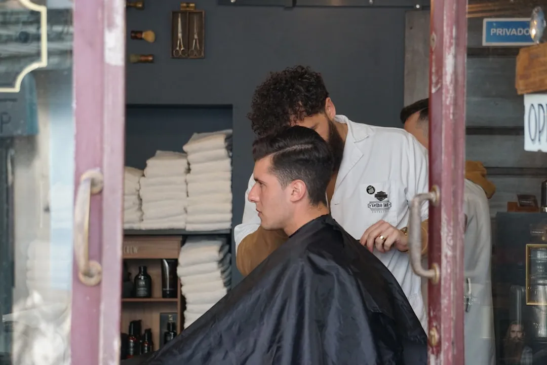 man in white shirt sitting on barber chair