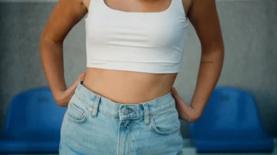 woman in white tank top and blue denim jeans