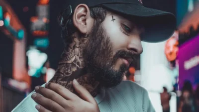 a man with a beard and tattoos on his neck