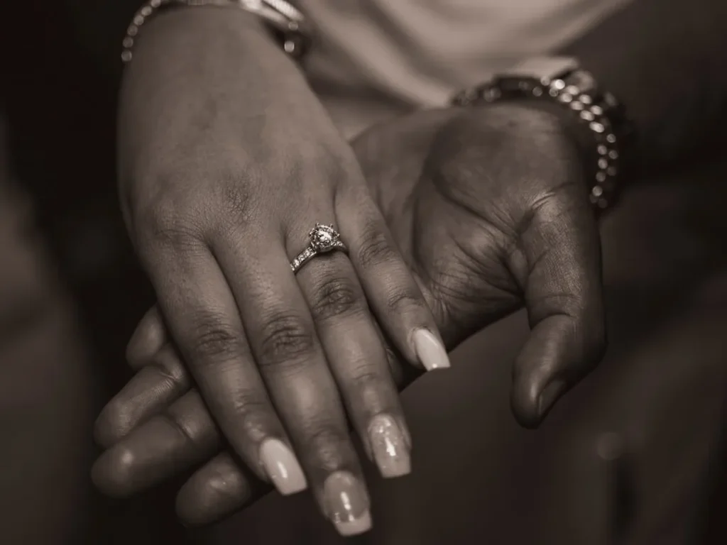 a close up of two people holding hands