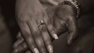 a close up of two people holding hands
