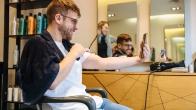 a man sitting in a chair in front of a mirror