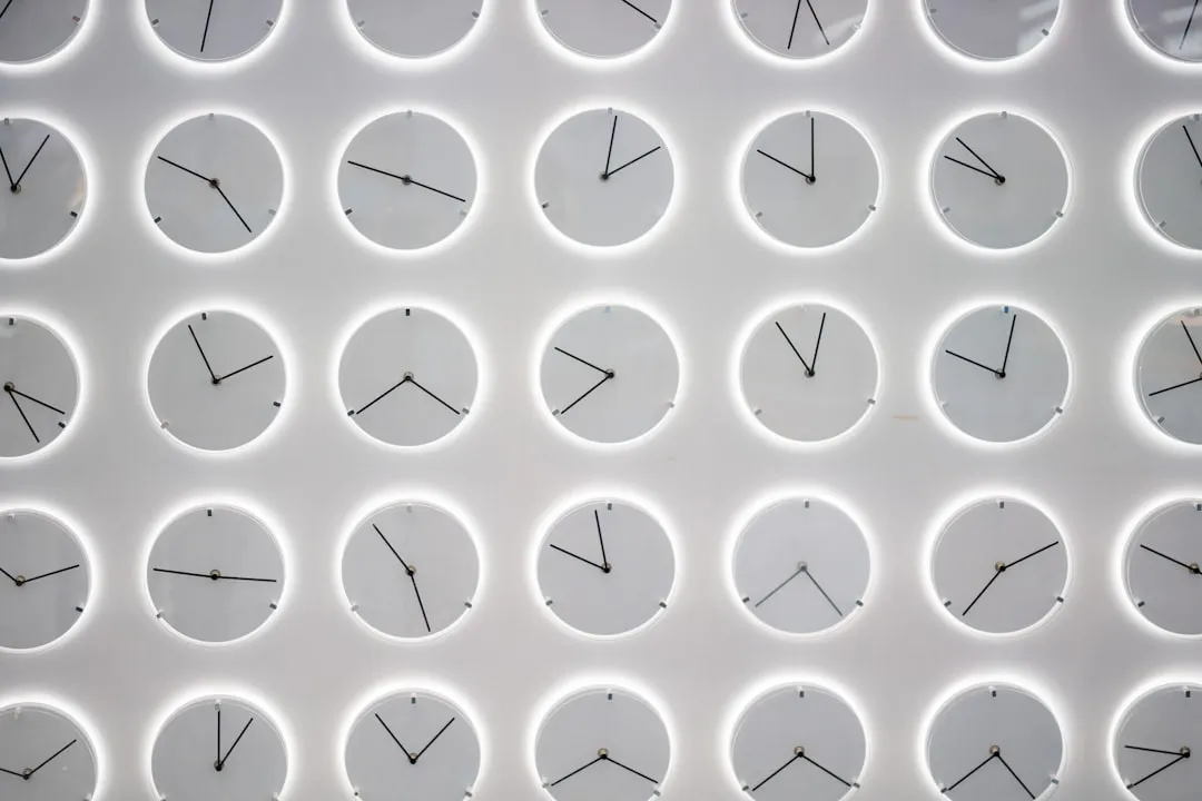 a white wall with many clocks on it