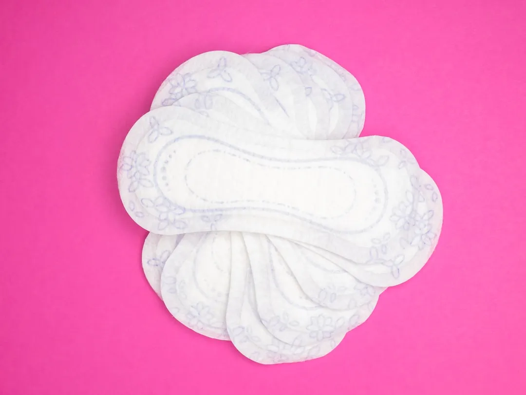 a close up of a cloth pad on a pink background