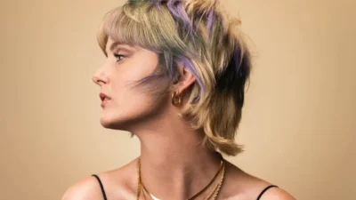 a woman with blonde hair wearing a necklace