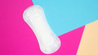 a pair of white socks sitting on top of a pink and blue background
