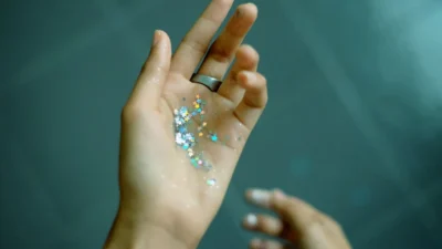 person showing hands with glitters